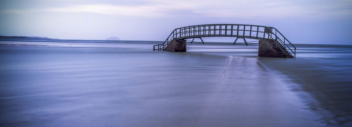 Lifeguard hut on beach against sky