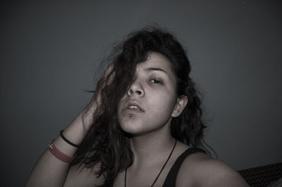 Portrait of young woman against white background