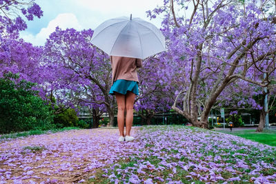 Woman standing on purple flower