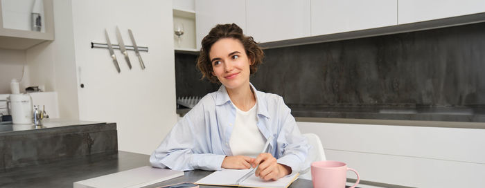 Portrait of young businesswoman working at office