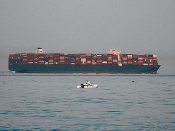 Ship sailing on sea against sky