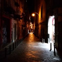 Walkway in city at night