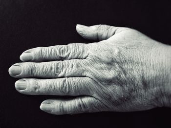 Close-up of hands over black background
