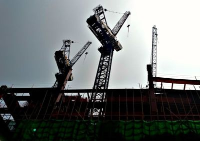 Low angle view of crane against clear sky
