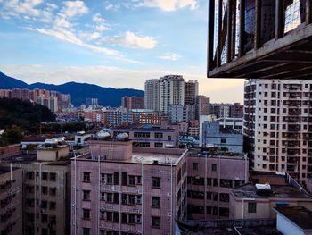 Skyscrapers against cloudy sky