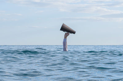 Cropped image of water in sea against sky