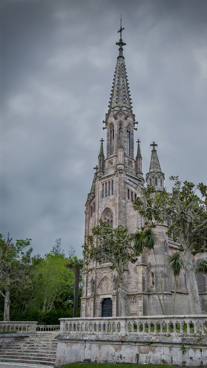 religion, place of worship, spirituality, cloud - sky, architecture, sky, low angle view, day, built structure, building exterior, travel destinations, outdoors, history, tree, no people, clock tower, bell tower