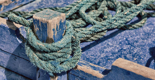 Close-up of rope tied on wood