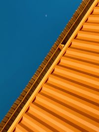 Low angle view of staircase against clear blue sky