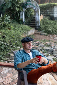 Portrait of man sitting on bench