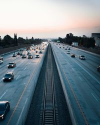 High angle view of railroad tracks amidst highway