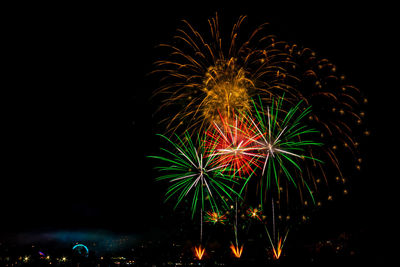 Low angle view of firework display at night