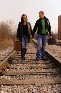 Full length of young couple walking on road
