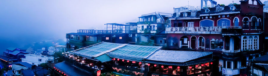 High angle view of buildings in city at dusk