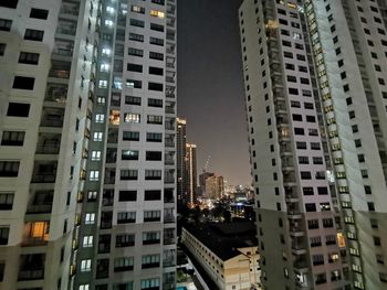 Low angle view of buildings in city at night