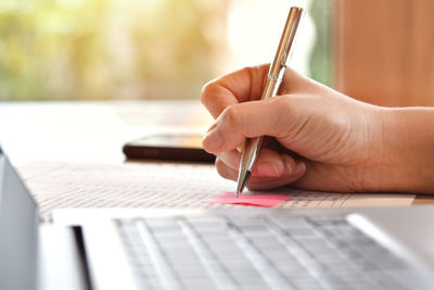 Close-up of hand holding book