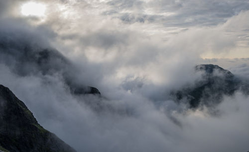Low angle view of clouds in mountains