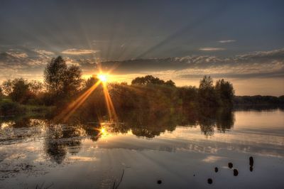 Scenic view of lake against sky during sunset