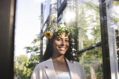 Portrait of smiling woman wearing flower tiara during swedish midsummer celebration