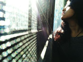 Young woman looking towards window at home