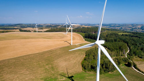 Windmill on field against sky