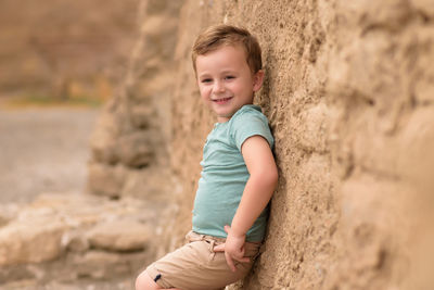 Portrait of boy standing on rock