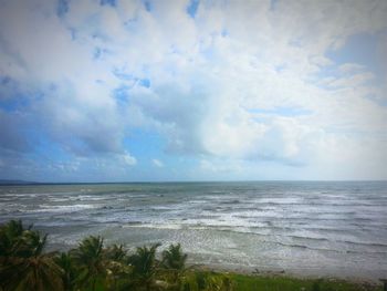 Scenic view of sea against cloudy sky