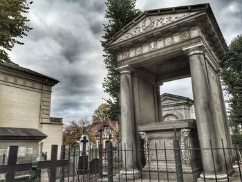 Low angle view of historical building against cloudy sky