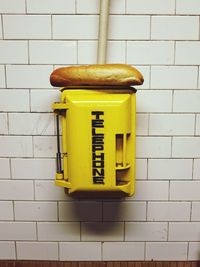 Close-up of yellow box on wall