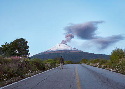 Road by mountain against sky