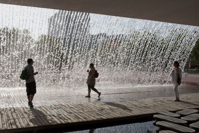 People walking on fountain