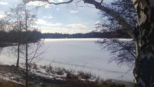 Scenic view of lake against sky during winter