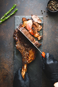 High angle view of man preparing food on barbecue grill