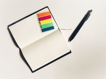 High angle view of pen on paper against white background