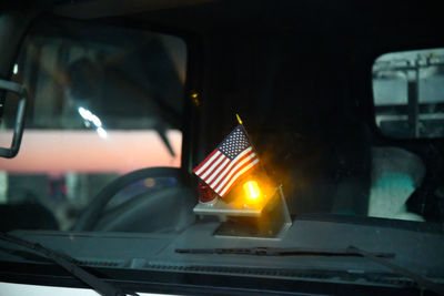 Illuminated light trails in city seen through window