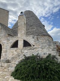 Low angle view of historical building against cloudy sky