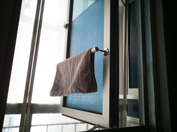 Low angle view of clothes hanging on glass window