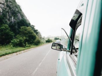 Close-up of vintage car on road