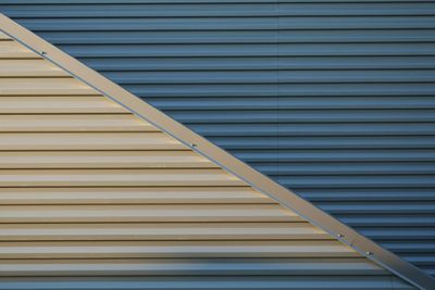 Light and shadow, on corrugated metal