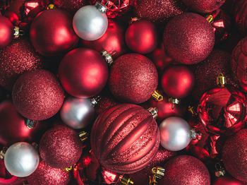 Close up of a variety of red and white christmas ball ornaments.