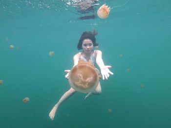 Full length of woman swimming undersea