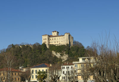 Low angle view of buildings against clear blue sky