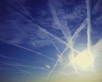 Low angle view of vapor trail in blue sky