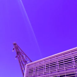 Low angle view of crane against blue sky