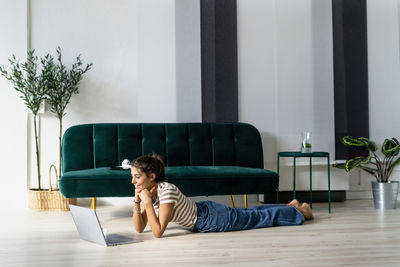 Woman using mobile phone at home