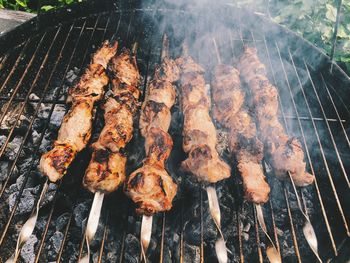 High angle view of meat on barbecue grill