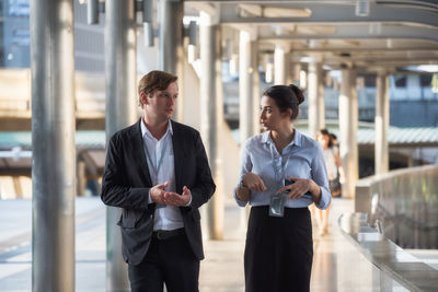 Business people talking while walking outdoors