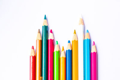 Close-up of colored pencils against white background