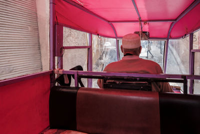 Rear view of man sitting in bus