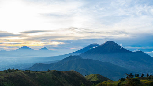 Scenic view of mountains against cloudy sky